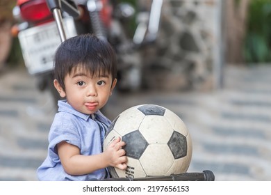 Boy Playing Soccer Ball There Was A Tongue Out And It Was Fun, Long Hair Playing In The House.