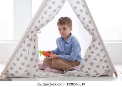 Boy Playing In The Teepee. Toddler Playing In Cotton Teepee With Window.