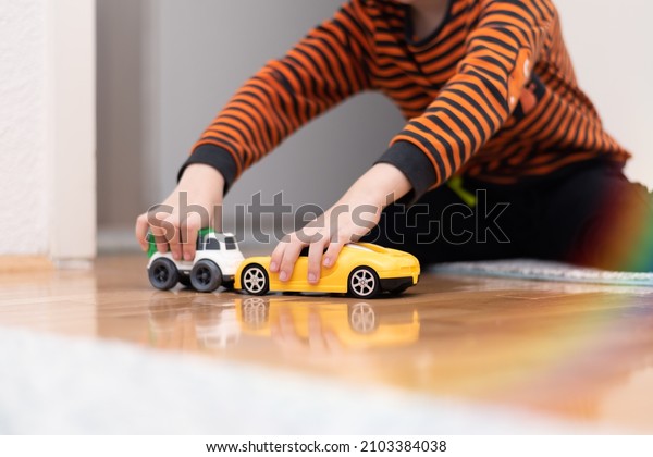 Boy playing toy cars. Kid with toys. Child and car\
at home