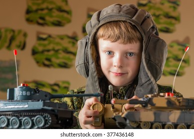 Boy playing toy. Radio-controlled toy military tank. Camouflage protective coloration . - Powered by Shutterstock