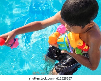 The Boy Playing  With Toys In The Pool