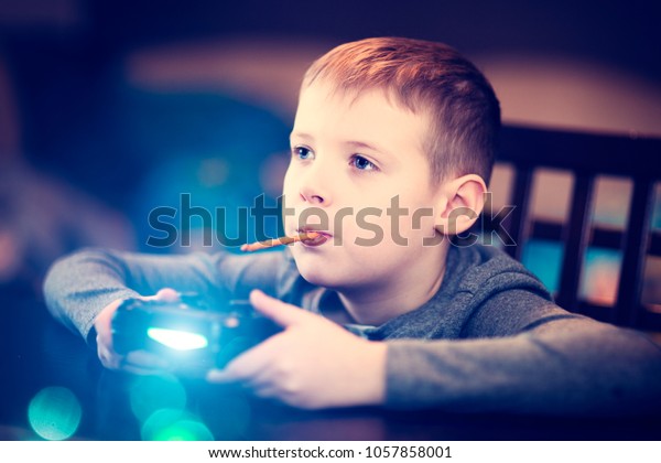 The boy is playing a TV\
game