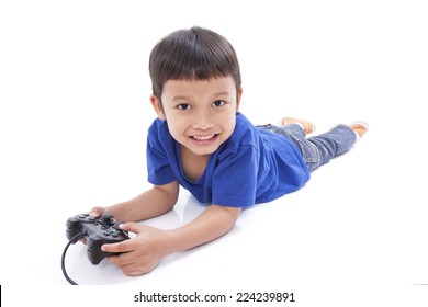 Boy playing video game and lying on the floor 