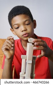 Boy Is Playing With Wooden Blocks.