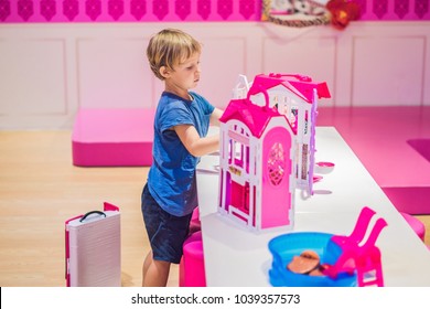The boy plays with girl toys and dolls