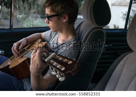 Similar – Young musician enjoying guitar on sunny day