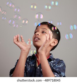 Boy plays with soap bubbles