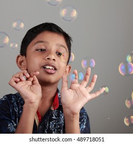 Boy plays with soap bubbles