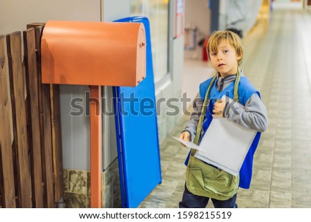 The boy plays that he is a postman