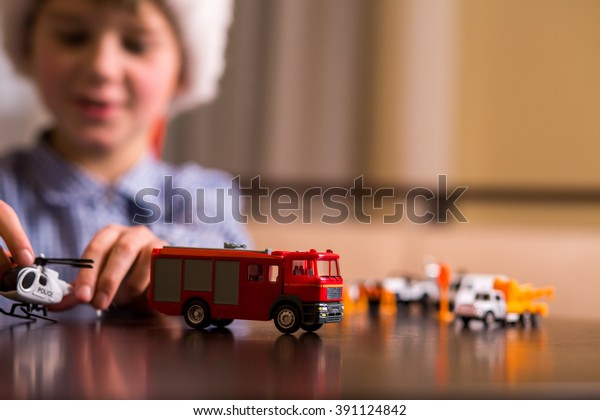 Boy\
plays with toy helicopter. Kid with toy police helicopter. Law\
enforcement and fire department. Always ready to\
act.