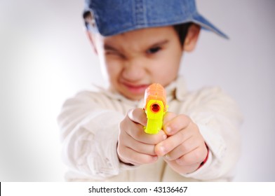 boy pointing gun at camera