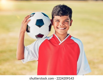 Boy portrait, field and soccer ball with smile for sport, fitness or training at soccer game, contest or competition. Athlete kid, football and happy with ball on shoulder for sports outdoor on grass - Powered by Shutterstock