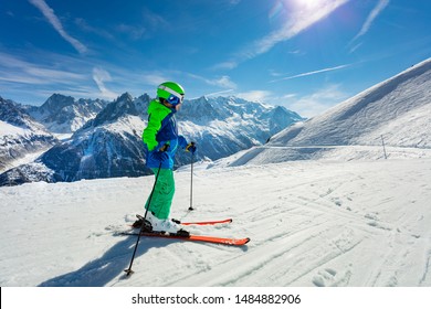 Boy Portrait On Snow Slope Over Mountain Peaks