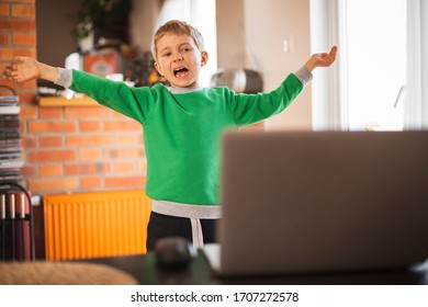 The Boy Practices At Home In Front Of The Computer As Part Of An Online Physical Education Lesson Due To Closed Schools Becouse Of Pandemic Coronavirus Covid-19