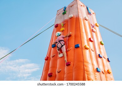 Boy practicing climbing on an inflatable climbing wall - Powered by Shutterstock