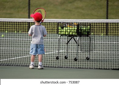 Boy practicing tennis