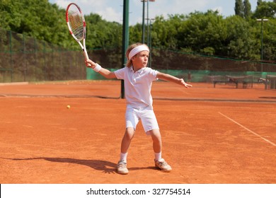 boy practicing tennis forehand