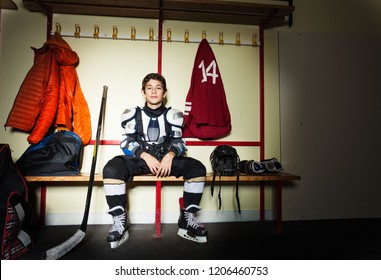 Boy preparing for ice hockey game in locker room - Powered by Shutterstock