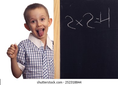 Boy Preschooler Standing At The Blackboard With Chalk In Hand Like Einstein.