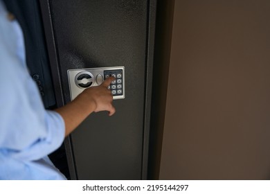 Boy Presses The Buttons On The Gun Safe