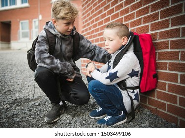 boy problem at school, sitting and consoling child each other