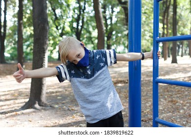 A Boy In A Protective Mask Shows The Class After A Workout In The Park