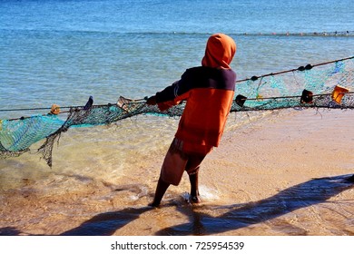 Boy Pulling Fishing Net From Sea In Ifaty Beach, Madagascar