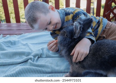 Boy and rabbit bonding on the terrace with treats - Powered by Shutterstock