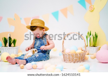 the boy with the rabbit. happy little boy in hat holding cute fluffy Bunny. Friendship with Easter Bunny. Spring photo with little boy with his Bunny. boy is holding a cute little rabbit.