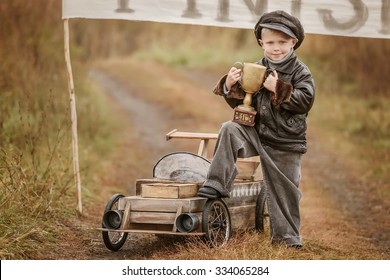 Boy Racer With A Triumphant Cup With His Homemade Wooden Car