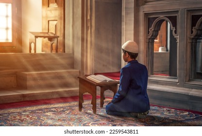 boy reading the Alquran in the mosque during Ramadan