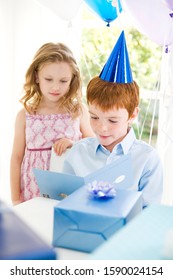 Boy Reading Birthday Card At His Party