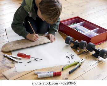 Boy redesigning his skateboard - Powered by Shutterstock