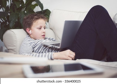 boy relaxing with his laptop