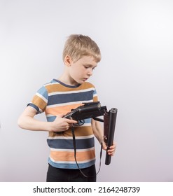 A Boy Reloads A Toy Gun. White Background. Copy Space.