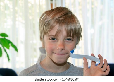 Boy Removes Blue Duct Tape From His Face. Child Mouth Is Taped Shut. The Concept Of Kid Wants To Talk.