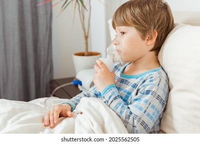 Boy with a respiratory syncytial virus, inhaling medication through an inhalation mask. Flu, coronavirus concept