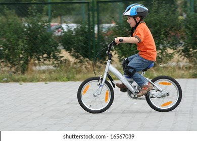 Boy Riding Bike In A Helmet