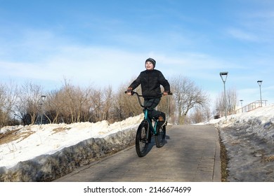 Boy Riding Bike On Sidewalk In Spring