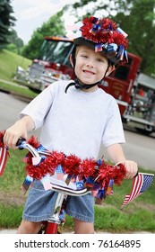 Boy Riding His Bike In A 4th Of July Neighborhood Parade