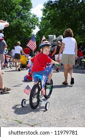 Boy Riding His Bike In A Neighborhood 4th Of July Parade