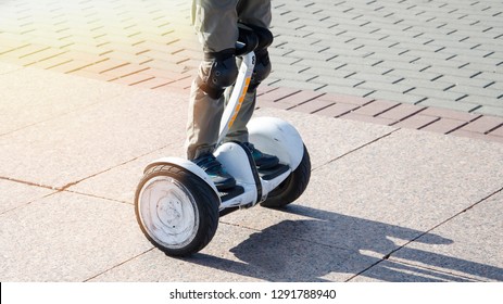 Boy Riding A Hoverboard In The Square