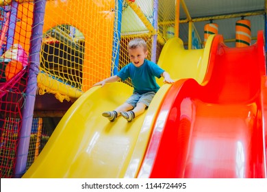 the boy is riding the slides