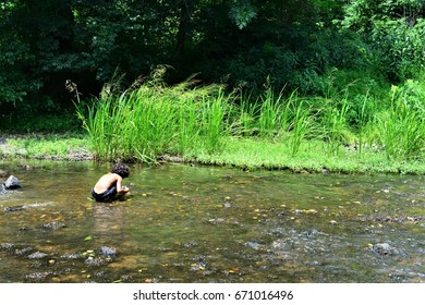 Boy in the River - Shutterstock ID 671016496