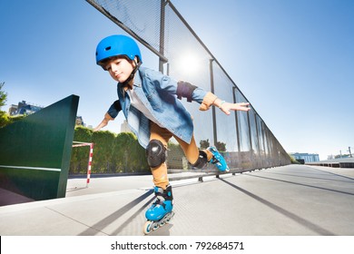 Boy In Roller Blades Doing Tricks At Skate Park