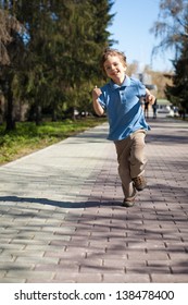 Boy Running Along Road In Park, Outdoor