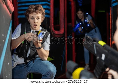 Boy running and dodging while playing lasertag