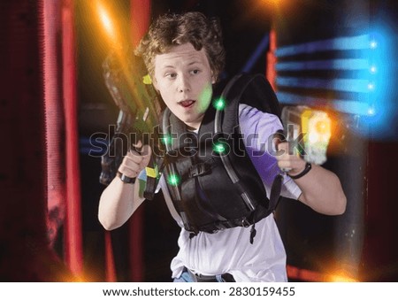 Boy running and dodging while playing lasertag