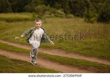 Boy Running Down Dirt Path, Young Child Sprinting Along Rural Trail Through Tall Grass, Determined Stride And Focused Expression, Late Afternoon Sunlight, Active Play And Exploration,