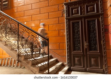 Boy Running Down The Stairs With Iron Railing In The Hallway Of Typical Historic Building, Center Of Odessa, Ukraine